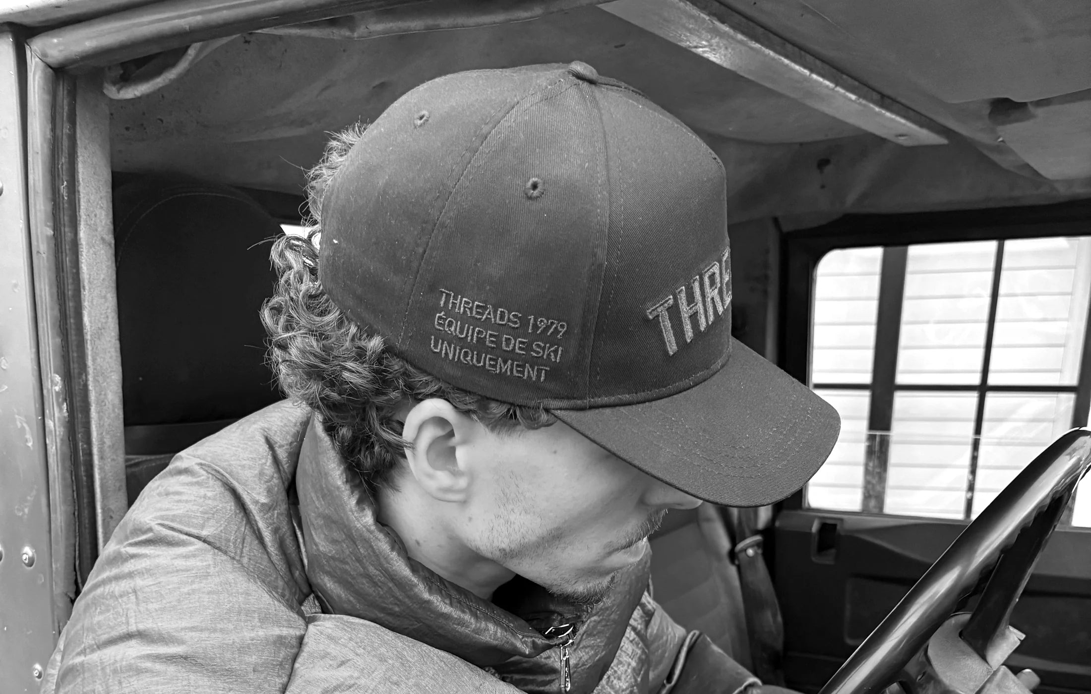 Founder of Threads Collective wearing the brand in a vintage vehicle