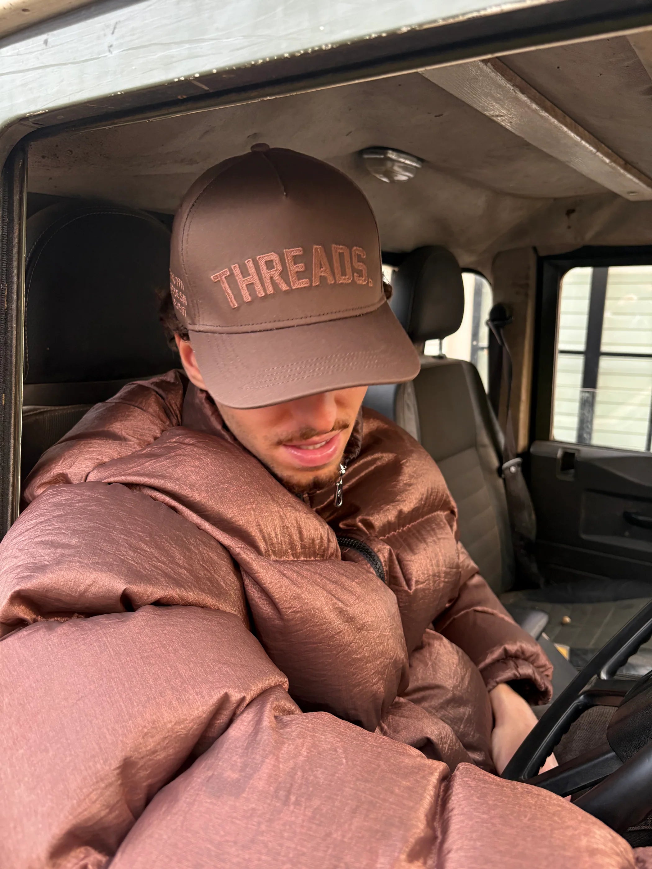 Threads Collective brown puffer and cap campaign